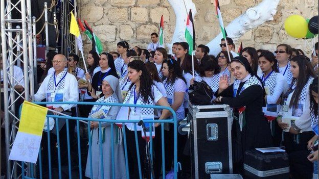 A nun and her charges wait for the Pope to arrive in Manger Square in Bethlehem