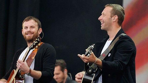 Kings of Leon and Chris Martin on stage