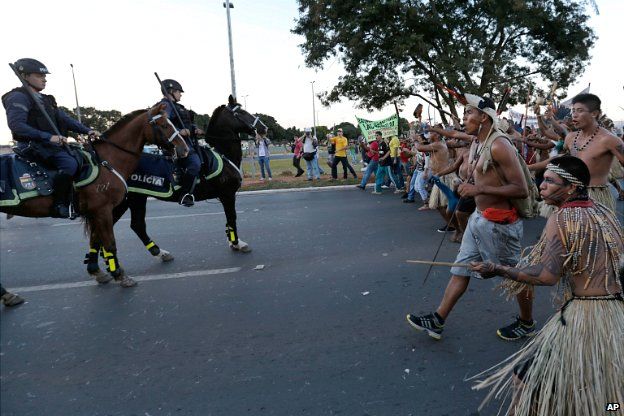 Indigenous protesters approach police during a protest against the football World Cup in Brasilia - 27 May 2014