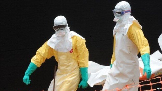 People carry the body of a person killed by Ebola at a medical centre in Guekedou, Guinea - 1 April 2014