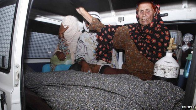 Women mourn over the body of their relative, Farzana Parveen, who was killed by family members, in an ambulance outside of a morgue in Lahore May 27