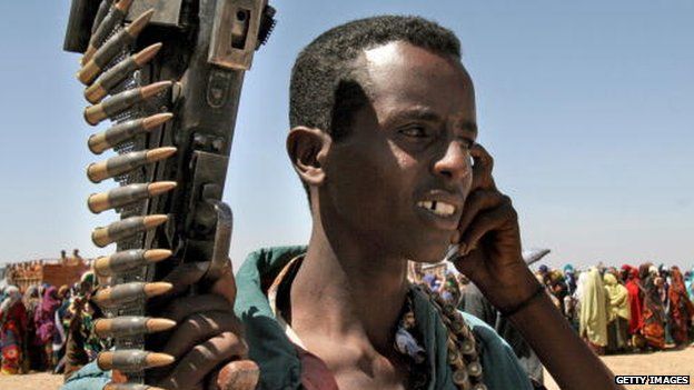 A Somali militant talks on a mobile phone