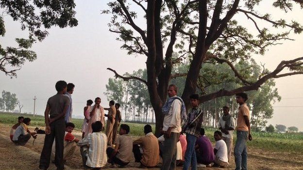 Villagers collect near tree where the girls were found in Badaun
