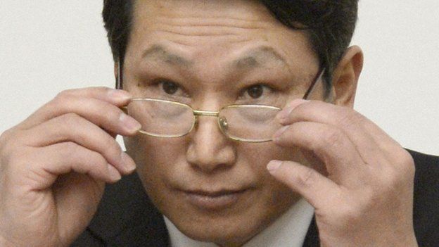 South Korean missionary, identified by the North as Kim Jong Uk, adjusts his glasses during a news conference in Pyongyang on 27 February 2014