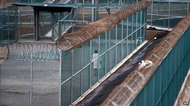 Unidentified detainee walks in the exercise yard at Guantanamo (8 April 2014)