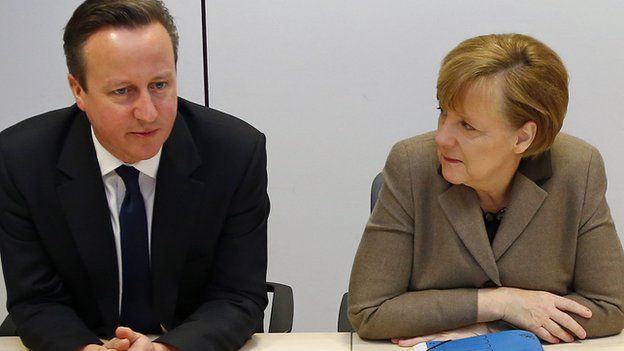 British Prime Minister David Cameron, left, and German Chancellor Angela Merkel speak during a meeting on the sidelines of an EU summit in Brussels on 21 March 2014.