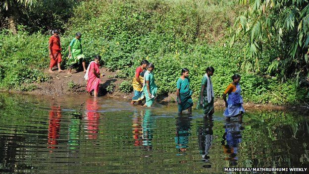 Women fording the river in Edamalakudi