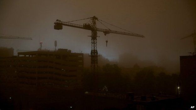 A tower crane is is enveloped in dust during a sandstorm in Tehran, Iran, 2 June 2014