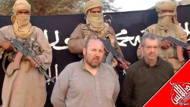 File photo: French national Serge Lazarevic (centre) and Philippe Verdon (right) being held by AQIM at an undisclosed location in 2011
