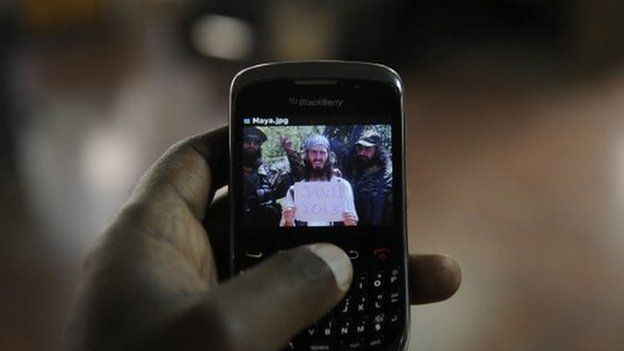 An undated photo of al-Amriki taken at an undisclosed location is seen on a mobile phone screen in Nairobi, Kenya in February 2013