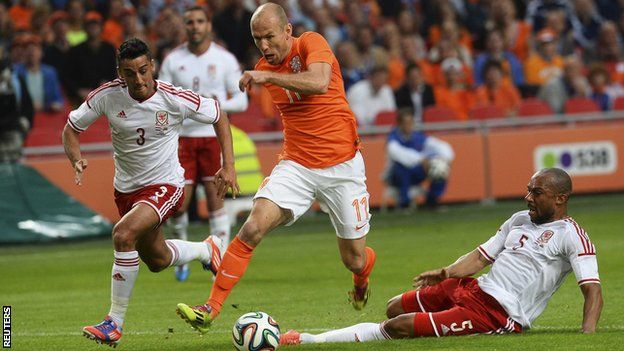 Netherlands forward Arjen Robben takes on the Wales defence