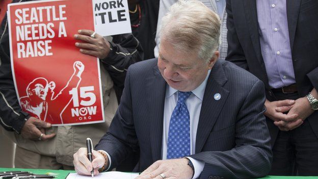 Seattle Mayor Ed Murray signs the city's minimum-wage increase on 3 June, 2014