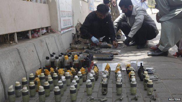 Officials defuse explosives and hand grenades outside Jinnah International Airport in Karachi (9 June 2014)