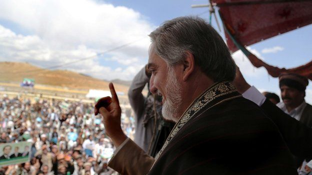 Afghan presidential candidate Abdullah Abdullah gestures as he greets supporters during an election campaign rally in Ghazni province on June 3, 2014.