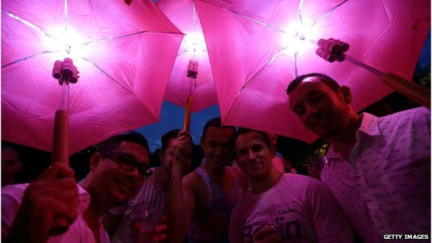 Participants dress in various shades of pink, pose for a photo during the 'Night Pink Dot' event arrange to increase awareness and understanding of the lesbian, gay, bisexual and transgender community in Singapore at Hong Lim Park on 30 June, 2012 in Singapore