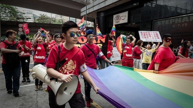 Participants hold a flag during the gay pride parade in Hong Kong, 9 November 2013