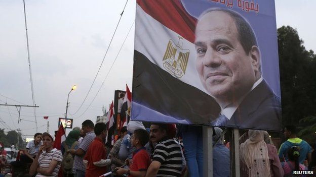 Egyptians celebrate after the swearing-in ceremony of President Abdel Fattah al-Sisi, in front of the Presidential Palace in Cairo, 8 June 2014