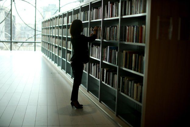 Woman browsing at library stack
