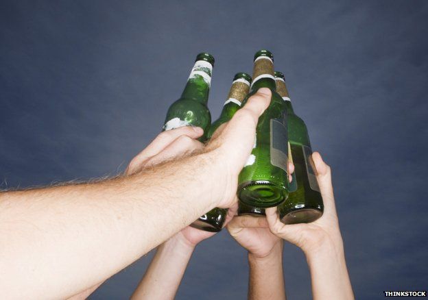 Friends toasting with beer bottles