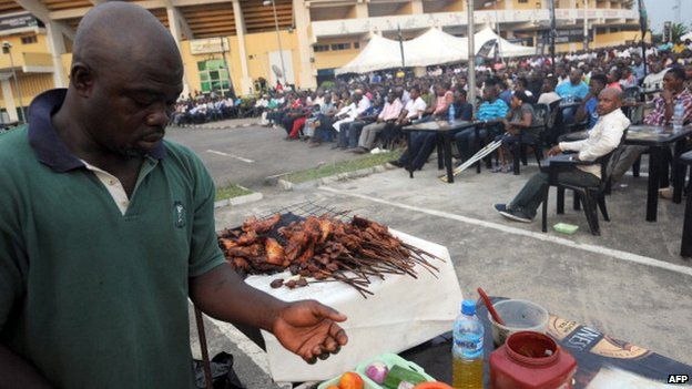 A man prepares barbecue popularly known as Suya for fans watching Nigeria's match against Ethiopia at a public viewing centre in Lagos - 29 January 2013