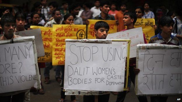 Activists hold placards to protest against the gang rape of two teenage girls, in New Delhi, India, Saturday, May 31, 2014