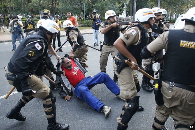 Riot police detain a man during a protest against the World Cup in Belo Horizonte - 12 June 2014