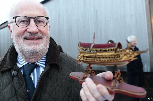 Giorgio Orsoni posing with a model boat during a visit to France (15 February 2014)