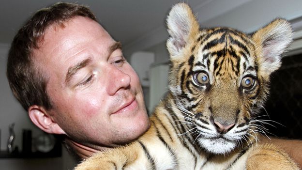 Giles Clark holding tiger cub