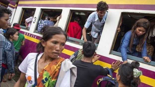 Cambodian workers get off a train as they prepare to migrate back to Cambodia at Aranyaprathet train station in Sa Kaew, Thailand, on 15 June.