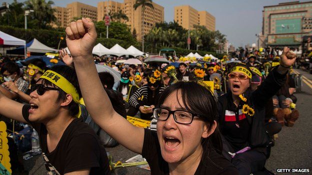 Protesters held flowers and shouted slogans as over 200,000 people rally on 30 March in Taipei opposing a contentious cross-strait service trade agreement with China.