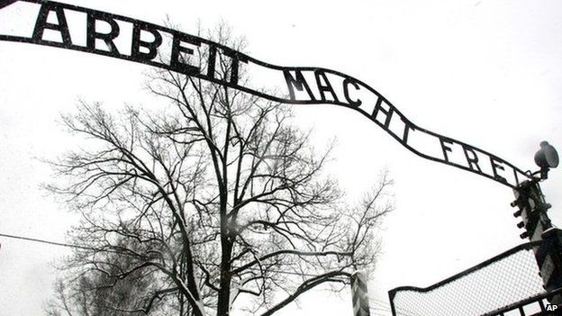 Visitors walk through the entrance gate of the Auschwitz Nazi concentration camp in Oswiecim, southern Poland 26 January 2005