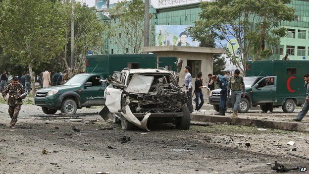 Afghan security personnel investigate the site of a suicide attack in Kabul. Photo: 6 June 2014