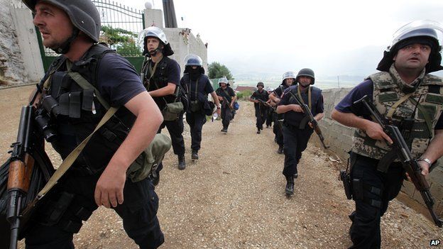 Albanian police enter the lawless village of Lazarat on 18 June 2014