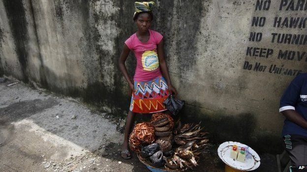 Twelve-year-old, Kemi Olajuwon, who has to drop out of school some days to sell smoked fish and make money in the Obalende area of Lagos, Nigeria, on June 17, 2014