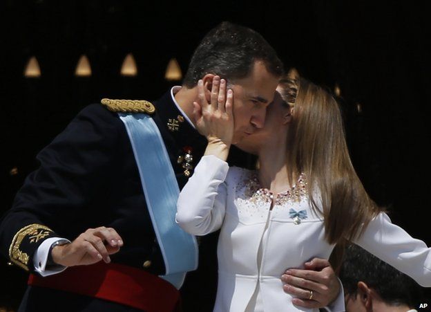 King Felipe is kissed by his wife Queen Letizia on the balcony of the royal palace in Madrid, 19 June