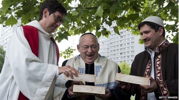 German Pastor Gregor Hohberg, Israeli Rabbi Tovia Ben-Chorin and German-Turkish Imam Kadir Sanci hold three bricks