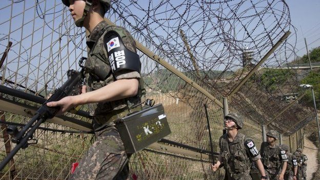South Korean army soldiers patrol along the barbed-wire fence at the demilitarized zone (DMZ) in Cheorwon, South Korea in May 2014