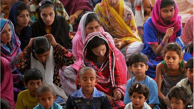 In this picture taken on June 22, 2014, internally displaced Pakistani Christians fleeing a military operation in the North Waziristan tribal agency attend a church service in Bannu.
