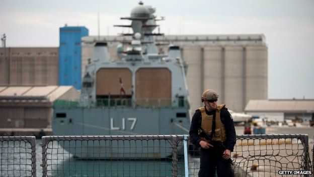 A sailor patrols the deck of a Norwegian Navy vessel used to transport chemical weapons out of Syria - 2 January 2014