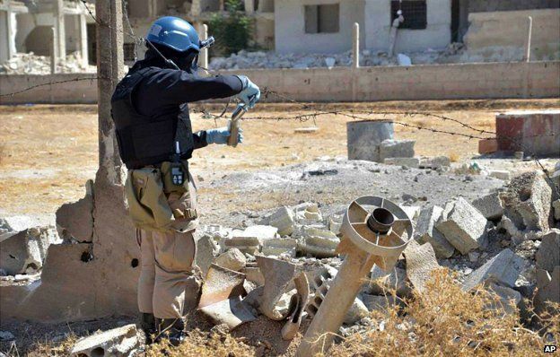 A UN investigator takes samples from the site of a suspected chemical weapons attack in Damascus - 28 August 2013