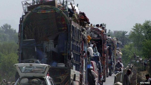 People fleeing the military offensive against the Pakistani militants in North Waziristan, travel atop a vehicle with their belongings while entering Bannu, located in Pakistan's Khyber-Pakhtunkhwa province, June 20, 2014.