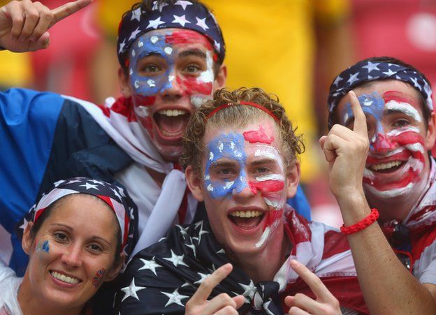 United States fans cheer in the rain prior to the 2014 FIFA World Cup Brazil group G match between the United States and Germany