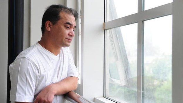University professor, blogger, and member of the Muslim Uighur minority, Ilham Tohti pauses for a few moments for a view from the window before a classroom lecture in Beijing on 12 June 12 2010.