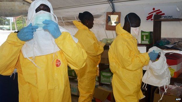 Members of Medecins Sans Frontieres don protective gear at Donka Hospital in Conakry, Guinea. 28 June 2014