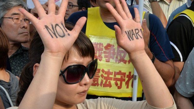 A protester shows "No War" sign on her palms during a rally in front of the prime minister"s official residence in Tokyo on July 1, 2014.