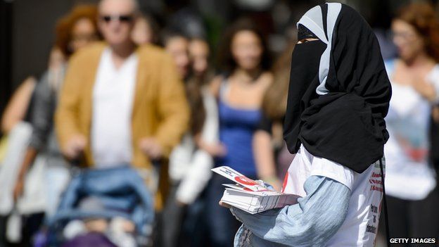 Islamic Central Council of Switzerland (ICCS - CCIS) member Nora Illi distributes flyers in Lugano against an upcoming cantonal vote on banning face-covering headgear in public places on 18 September 2013.