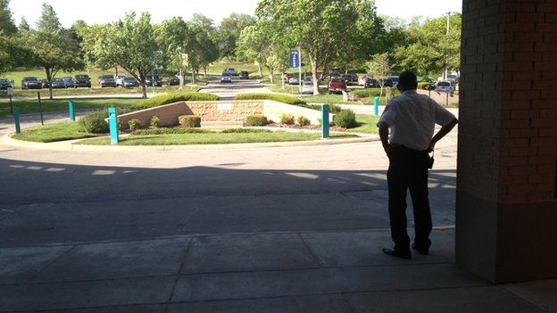 A security guard looking at the car park of the Jewish Community Center