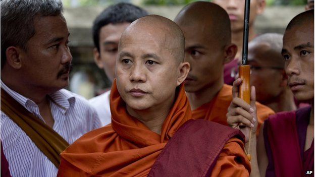 Controversial Buddhist monk Wirathu (centre) who is accused of instigating sectarian violence between Buddhists and Muslims through his sermons, stands with other monks in support of five Buddhist monks who were forced to give up their robes outside a courthouse in Yangon, Myanmar, on 20 June 2014.