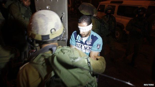 Israeli police detain a Palestinian in the city of Hebron on 2 July 2014