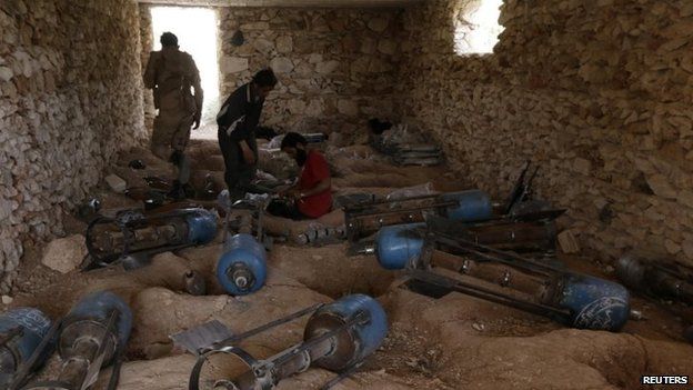 Free Syrian Army fighters prepare weapons